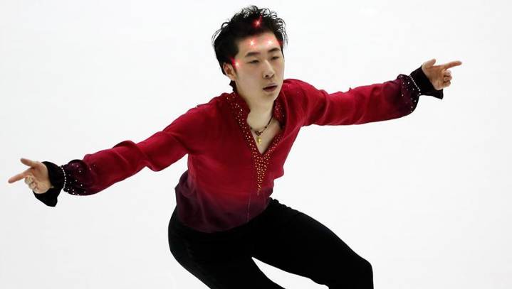 Chinese Figure Skater Executes Flawless Performance While Several Laser Dots Dance Around Forehead