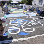 Parking spots used as colorful protest against Florida crackdown on rainbow crosswalks