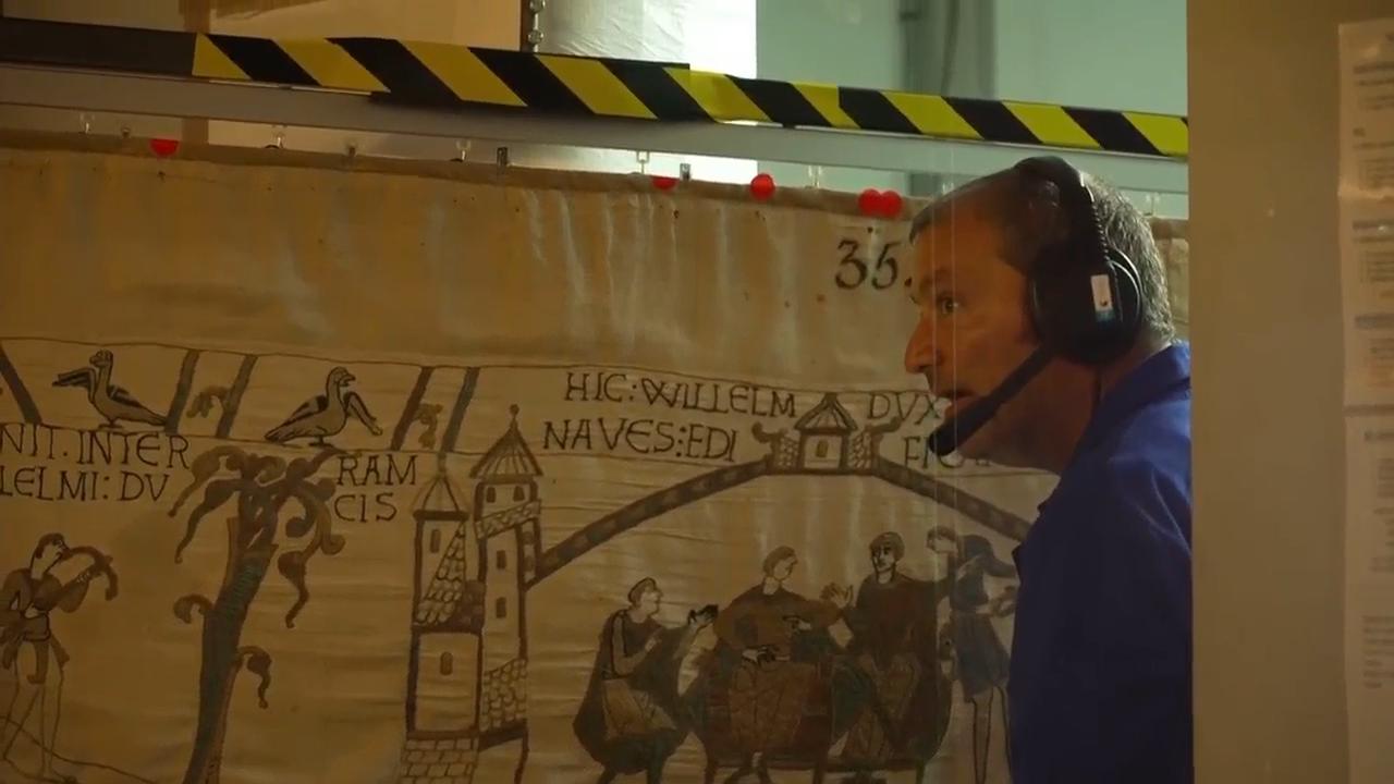 Unhooking of Bayeux Tapestry ahead of its transfer to the UK
