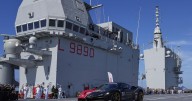 One man in an Italian supercar atop an aircraft carrier. And a record in his sights