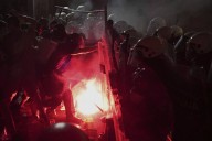 Tear gas is fired in Serbia at thousands of protesters demanding free elections and justice