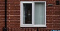 "I was bleeding... I thought it was a brick": Dad speaks of horror moment gunshot blasts through window of family home