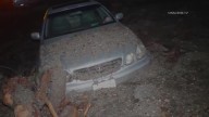 Mudslides trap drivers, bury roads and damage homes in Southern California