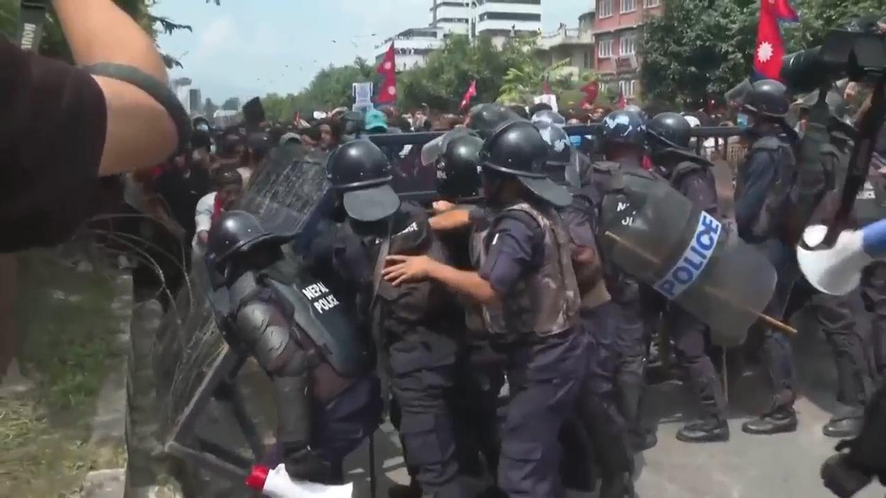 Protesters in Nepal surround parliament and clash with police as government blocks social media