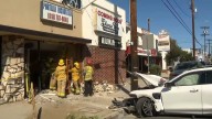 Car crashes into building, man pinned under vehicle in Valley Glen