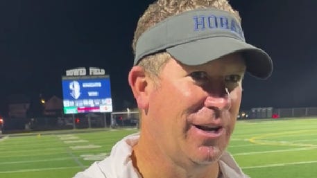 Hoban football coach Tim Tyrrell talks after Walsh game