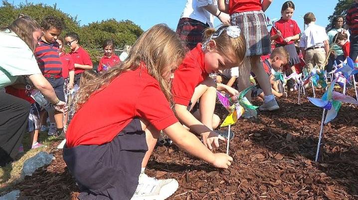 Students plant pinwheels for peace at Annunciation Catholic School