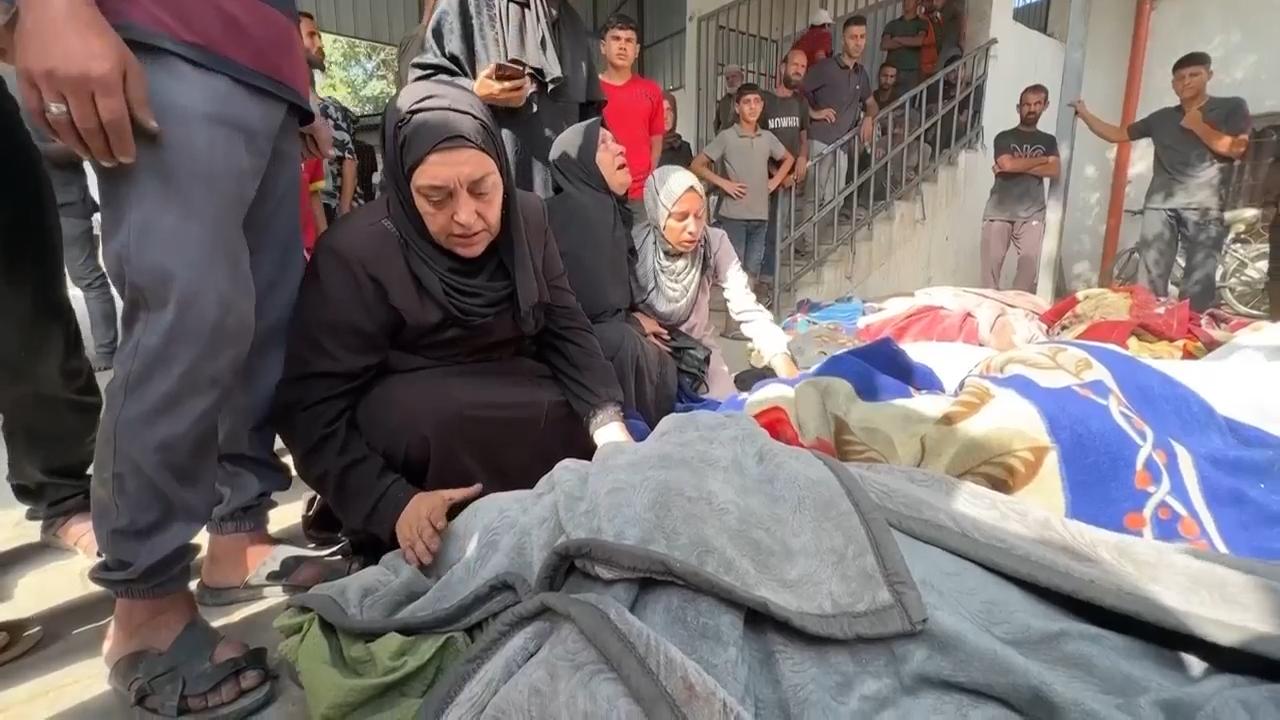 Relatives mourn after Israeli strikes in Gaza City kill at least 34 Palestinians