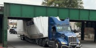 Semi-truck stuck under Brady Street bridge