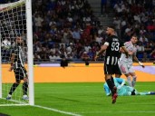 Cash-strapped Lyon win to climb level on top in France