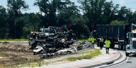 Semi-truck carrying junk cars flips, spills gas on roundabout near Hyundai plant entrance