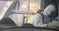 Hazmat-suited firemen board British Airways flight after emergency landing due to 'fumes in the plane'