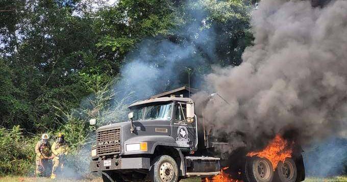 Firemen respond to burning dump truck