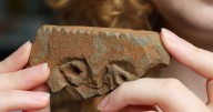 Archaeology student finds rare stone carving in Scotland that may show Pictish face