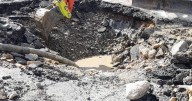 Part of main village road remains closed after water main burst