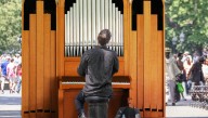 Unemployed Church Organist Playing On Street Corner For Tips