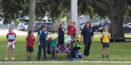 Parents and children rally outside of Wilkinson Elementary as the school board announces possible closure