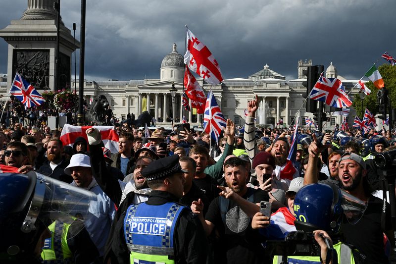 Police and protesters scuffle as 110,000 join anti