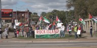 Dozens of people walk the Centennial Bridge showing support to Palestine