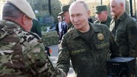 Putin dons military fatigues in war games 500 miles from the frontline in a show of strength to the West