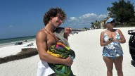 Manatee County lifeguard Owen Munday rescues injured pelican