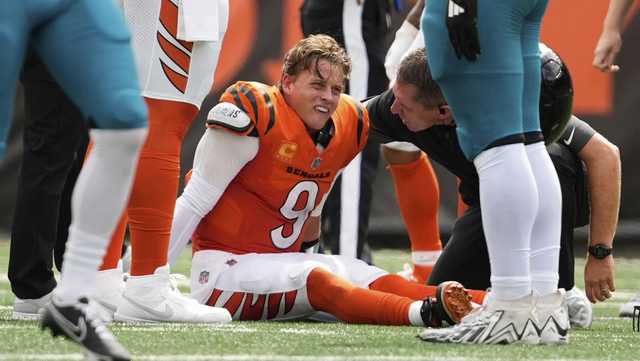 Joe Burrow seen leaving Bengals locker room on crutch, with foot in boot after sustaining toe injury