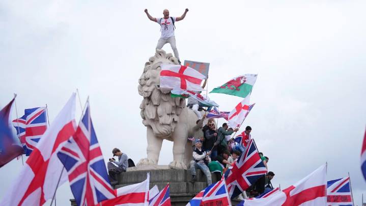 Supporters of far-right activist Tommy Robinson clash with London police during massive protest
