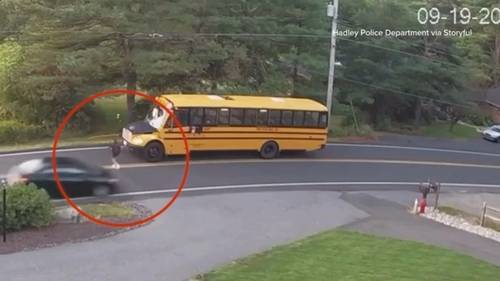 Student almost hit as driver ignores school bus stop sign, video shows in Hadley, Massachusetts