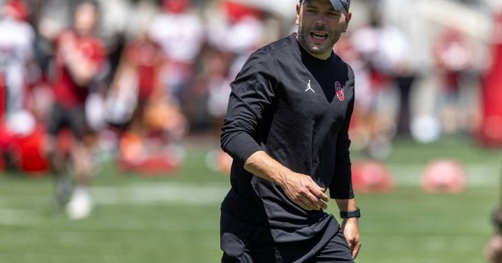 Quarterback coach John Kuceyeski aids Michael Hawkins Jr.'s preparation as OU starter