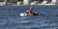 Person rescued after sailboat capsizes off the coast of Clinton