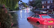 Road under water after torrential rain hits Greater Manchester as flood warning issued