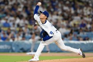 Dodgers edge Giants despite taking a walk on the wild side