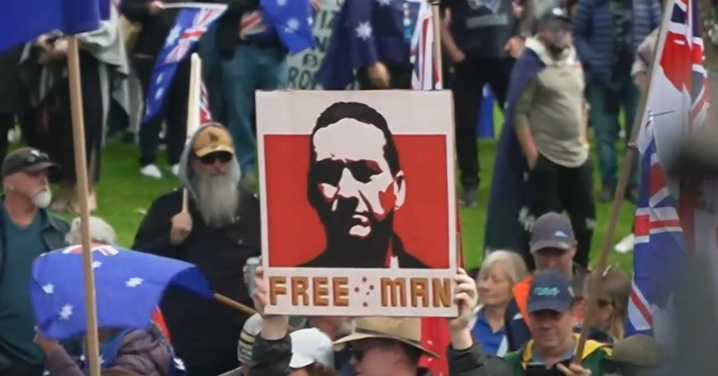 Man charged after displaying Dezi Freeman sign at rally