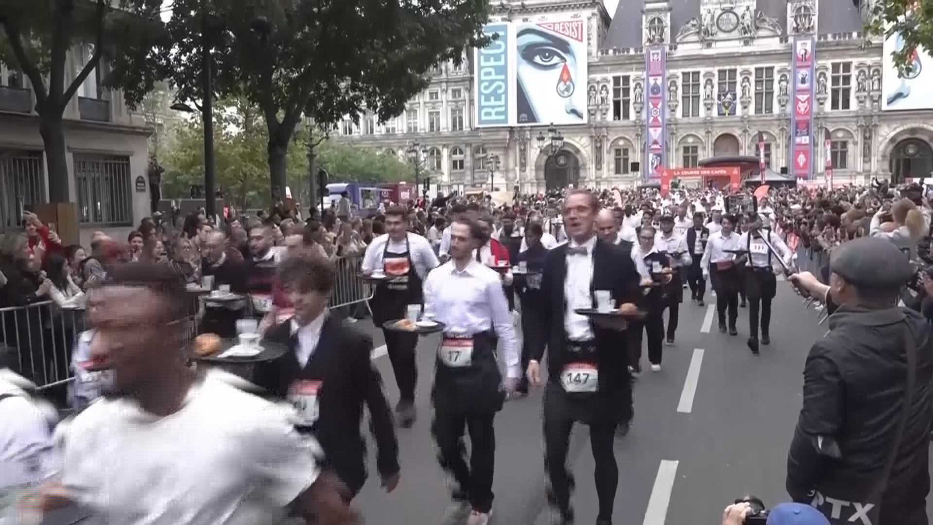 Servers in Paris take part in race through streets showing off loaded tray