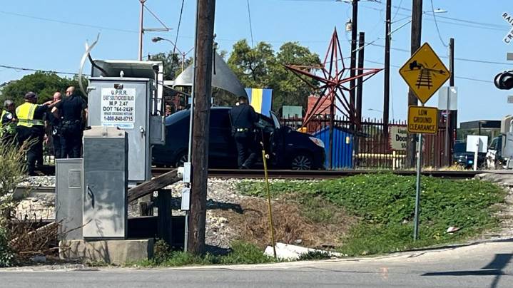 Train hits car stuck on tracks in train depot