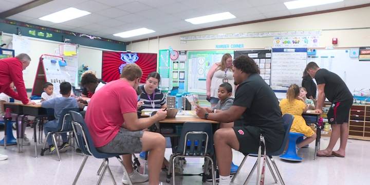 Players from Badger Football team visit Sandburg Elementary School, inspire kids to read