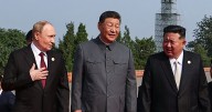 Chinese leader XI Jinping cozies up to Vladimir Putin at military parade