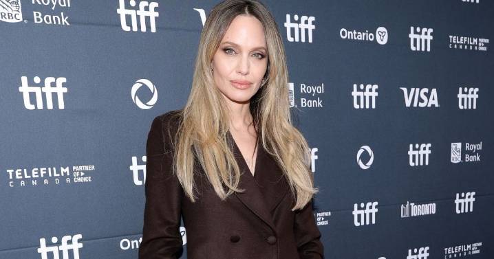 Angelina Jolie Puts on a Leggy Display in Repurposed Trench Coat Dress at TIFF