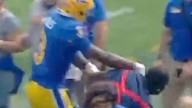 College football players 'go to war' with ball boy in shocking scenes - but Louisville equipment guy has last laugh