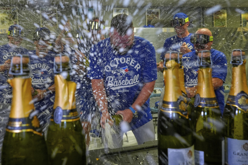American League-best Blue Jays beat Royals 8-5 and clinch their 1st postseason berth since 2023