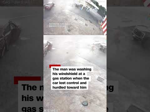 Man narrowly escaping out-of-control car at gas station