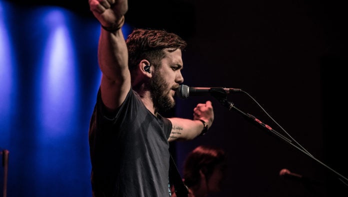 Worship Leader Invites Congregation To Join Him In Time Of Worshiping The Sound Of His Own Voice