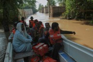 Floodwaters begin receding in a major Pakistani city but nearby towns face evacuations