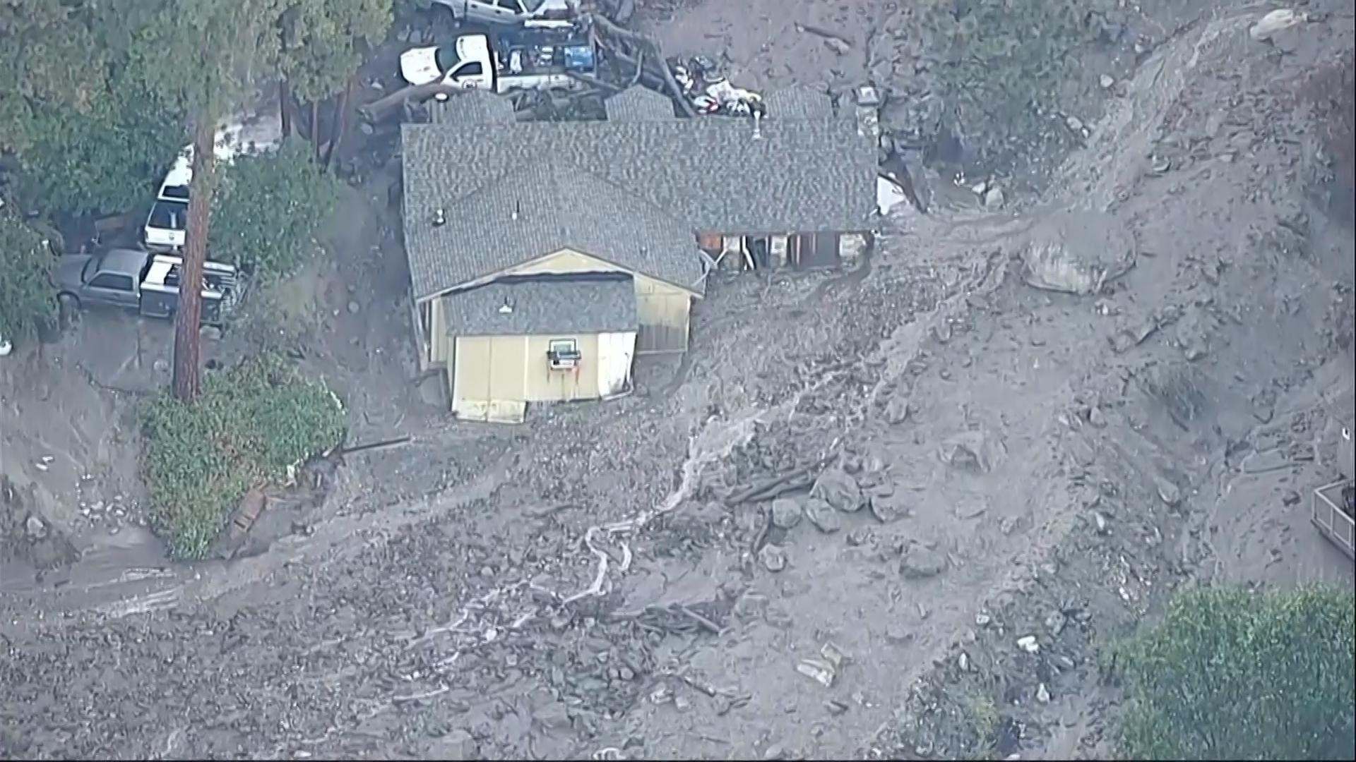 Mudslides trap drivers, bury roads and damage homes in Southern California