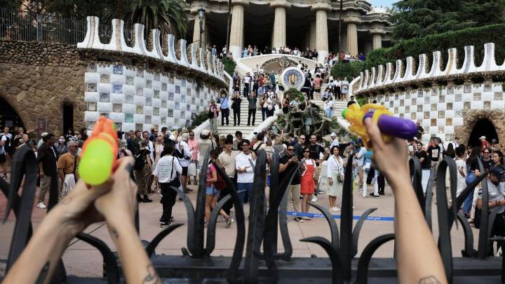 Activists squirt water guns at tourists at anti-tourism protest in Barcelona