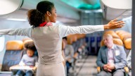 Flight Attendant On A Boeing Gives Presentation On What To Do In The Unlikely Event Of A Safe Landing