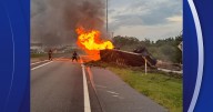 Witness rushes to help driver after a tractor-trailer overturns and bursts into flames