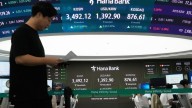 Asian shares trade mixed after US stocks set more records