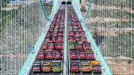 World's tallest bridge put to the ULTIMATE test as fleet of 96 trucks loaded with 3,360 tons of cargo park on crossing