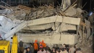 Rescuers run oxygen to survivors in Indonesia school building collapse that buried dozens